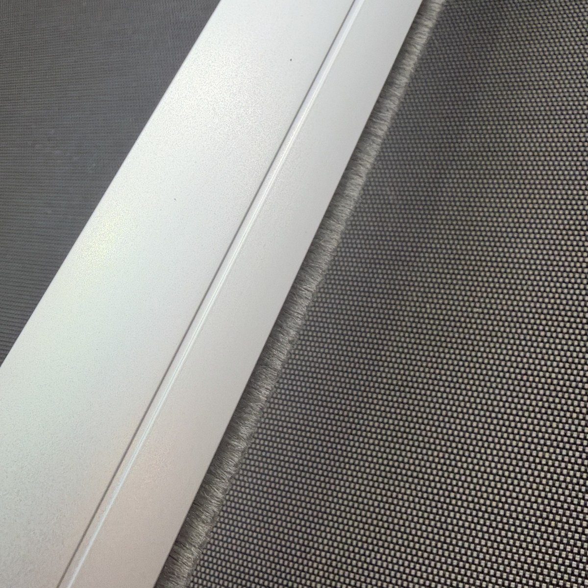 Charcoal brush strip on a D30 roller blind bottom rail